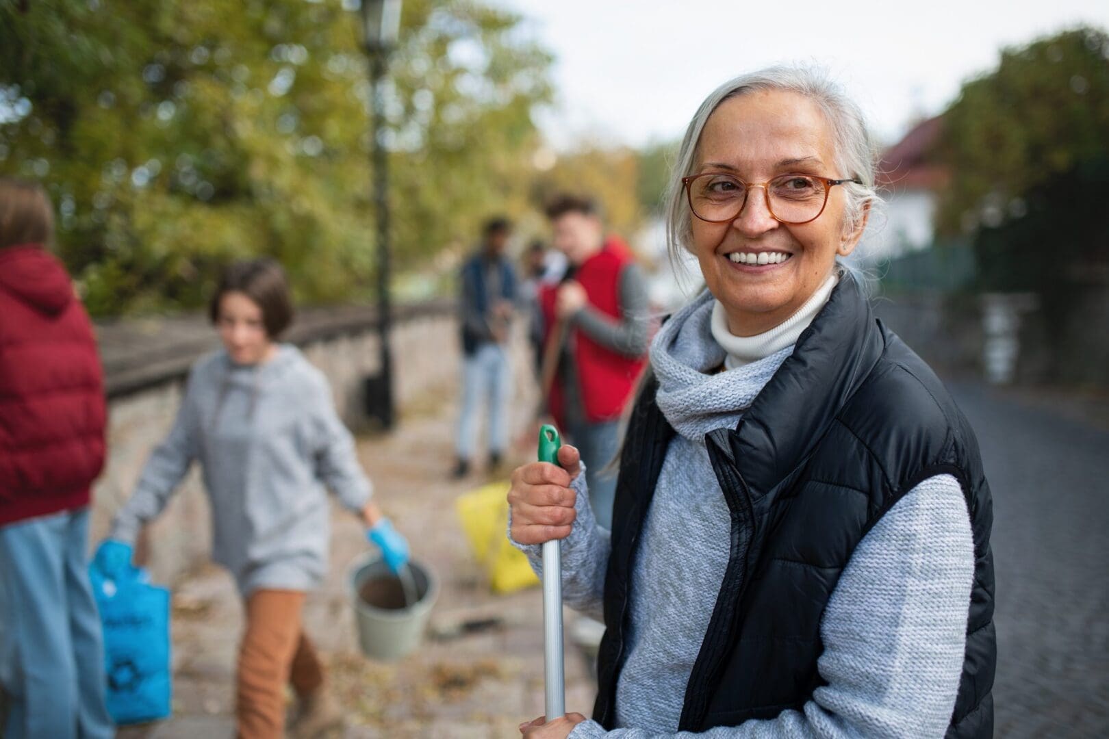 Elderly woman participating in community cleanup
