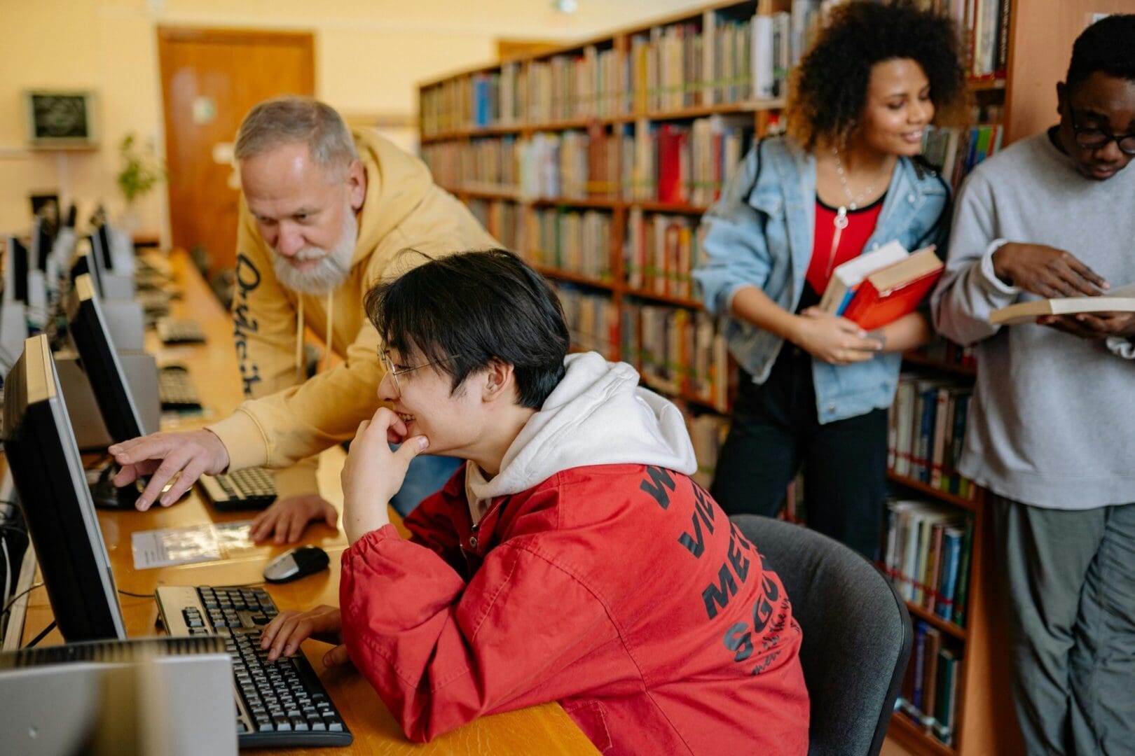 People studying and browsing books in a library.